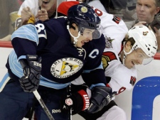 Pittsburgh Penguins' Sidney Crosby (87) collides with Ottawa Senators' Milan Michalek (9) along the boards during the first period of an NHL hockey game, Friday, Nov. 25, 2011, in Pittsburgh. (AP Photo/Gene J. Puskar)
