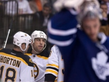 Boston Bruins' Milan Lucic (centre) celebrates his goal with teammate Nathan Horton (left) as Toronto Maple Leafs goaltender Jonas Gustavsson (right) reacts during third period NHL hockey action in Toronto on Wednesday, Nov, 30, 2011. (THE CANADIAN PRESS/Chris Young)
