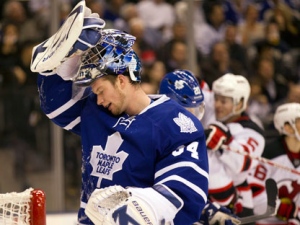 Toronto Maple Leafs goaltender James Reimer reacts as the New Jersey Devils celebrate their second goal during first period NHL action in Toronto on Tuesday, Dec. 6, 2011. (THE CANADIAN PRESS/Frank Gunn)