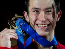 Gold medalist Patrick Chan of Canada holds up his medal during medal ceremonies at the ISU Grand Prix of Figure Skating Final Saturday, Dec. 10, 2011 in Quebec City. (THE CANADIAN PRESS/Paul Chiasson)