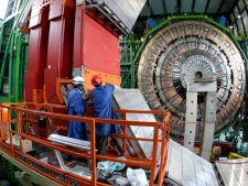 In this Thursday, March 22, 2007 file photo two engineers works to assemble one of the layers of the world's largest superconducting solenoid magnet (CMS, Compact Muon Solenoid) at the European Organization for Nuclear Research (CERN)'s Large Hadron Collider (LHC) particule accelerator, in Geneva, Switzerland. Scientists at CERN will hold a public seminar Tuesday Dec. 13, 2011 to present their latest findings from the search for an elusive sub-atomic particle known as the Higgs boson. Physicists are increasingly confident that they have narrowed down the place where it will be found and may even already have hints at its existence hidden away in reams of data. (AP Photo/KEYSTONE/Martial Trezzini, File)