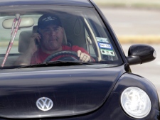 A driver uses a cellphone while driving Wednesday, Dec. 14, 2011. (AP Photo/David J. Phillip)