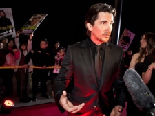 In this file photo taken Monday, Dec. 12, 2011, English actor Christian Bale speaks to journalists during an interview on the red carpet as he arrives for an event of the Zhang Yimou-directed new movie "The Flowers of War" in Beijing, China. (AP Photo/Andy Wong, File)