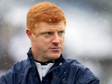 In an Oct. 29, 2011 file photo Penn State assistant coach Mike McQueary watches as the team warms up before a game at Beaver Stadium in State College, Pa. A grand jury alleges on March 1, 2002, Jerry Sandusky was discovered by graduate assistant McQueary raping a naked boy who had his hands pressed against the shower wall. (AP Photo/The Patriot-News, Joe Hermitt/file)