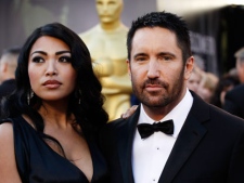 Composer Trent Reznor, right, arrives with his wife Mariqueen Maandig before the 83rd Academy Awards on Sunday, Feb. 27, 2011, in the Hollywood section of Los Angeles. (AP Photo/Matt Sayles)