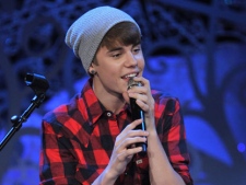 Justin Bieber performs songs at Massey Hall in Toronto on Wednesday, Dec. 21, 2011. (MuchMusic/George Pimentel for WireImage)