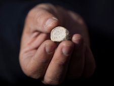 A rare clay seal is displayed during a news conference at the archaeological site known as the City of David in east Jerusalem, Sunday, Dec. 25, 2011. Israeli archaeologists say they have unearthed a rare clay seal that appears to be linked to religious rituals that took place at the Jewish Temple 2,000 years ago. (AP Photo/Oded Balilty)