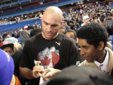 UFC welterweight Sean Pierson, of Pickering, Ont., signs autographs after delivering an anti-bullying message to young fans at the Roger's Centre in Toronto on Tuesday, Dec. 6, 2011. THE CANADIAN PRESS/Colin Perkel