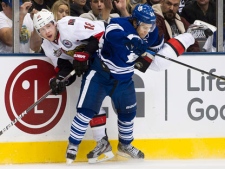 Toronto Maple Leafs defenceman John-Michael Liles, front, takes out Ottawa Senators forward Jesse Winchester, back, during third period NHL hockey action in Toronto on Saturday, Nov. 12, 2011. (THE CANADIAN PRESS/Nathan Denette)