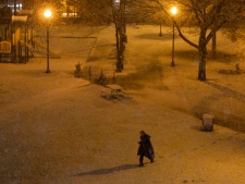 A man walks through a park during heavy snowfall in Toronto on Tuesday, Dec. 27, 2011. (THE CANADIAN PRESS/Pawel Dwulit)
