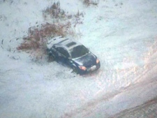 A car rests in a ditch after sliding off a slippery highway north of Toronto on Wednesday, Dec. 28, 2011. (CTV)
