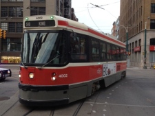 A TTC streetcar is pictured at Spadina Avenue and Adelaide Street after a live hydro wire fell on top of it Thursday, Dec. 29, 2011. The operator and four passengers were stuck on the streetcar until the wire was removed. (CP24/Cam Woolley)