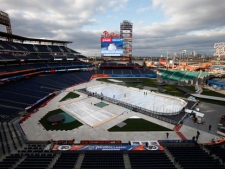 Crews work on the ice rink in preparation for NHL hockey's Winter Classic at Citizens Bank Park, Wednesday, Dec. 28, 2011, in Philadelphia. The New York Rangers and the Philadelphia Flyers are scheduled to play on Monday. (AP Photo/Matt Rourke)