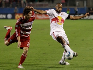 FC Dallas defender Zach Loyd, left, looks on as New York Red Bulls forward Thierry Henry makes a pass during an MLS Cup match Wednesday, Oct. 26, 2011, in Frisco, Texas. Henry scored a goal helping the Red Bulls to the 2-0 win over FC Dallas. (AP Photo/Tony Gutierrez)