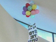 A banner unfurled in opposition to planned city cuts is shown inside city hall Monday. (CP24)