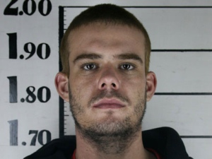 In this file photo taken June 11, 2010 and obtained by The Associated Press via Peru's America Television channel, Dutch citizen Joran van der Sloot holds his inmate number before been transferred to the Miguel Castro Castro prison in Lima.