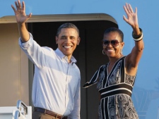 President Barack Obama and First Lady Michelle Obama wave before departing from Hickam Air Force Base in Honolulu, Monday, Jan. 2, 2012. (AP Photo/Eric Risberg)