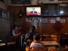 Syrians at a coffee shop in Damascus, Syria watch a televised broadcast of Syrian President Bashar Assad delivering a speech at Damascus University on Tuesday, Jan. 10, 2012. (AP Photo/Muzaffar Salman)