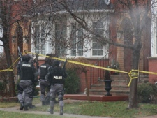 Police get ready to enter a home on Treetop Terrace on Jan. 12, 2012. (Photo courtesy Douglas Hughes via Twitter)