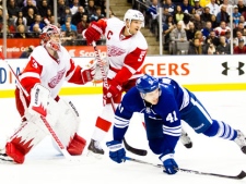 Toronto Maple Leafs left winger Nikolai Kulemin (41) is tripped up by Detroit Red Wings defenceman Nicklas Lidstrom in front of goaltender Jimmy Howard (35) during second period NHL action in Toronto on Saturday January 7, 2012. THE CANADIAN PRESS/Frank Gunn