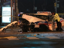 A female police officer was injured when her police cruiser crashed into the side of a TTC bus at Danforth Avenue and Main Street in Toronto early Friday, Jan. 13, 2012. (CP24/Tom Stefanac)