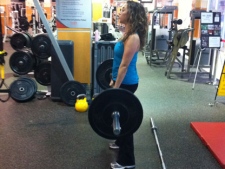 At the gym doing a dead lift three weeks after starting a fitness routine.