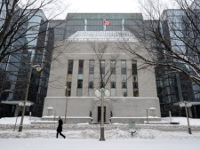 A pedestrian walks in front of the Bank of Canada in Ottawa on Tuesday, Jan. 17, 2012. THE CANADIAN PRESS/Sean Kilpatrick