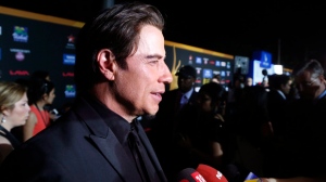 Actor John Travolta walks the green carpet as he arrives for the 15th annual International Indian Film Awards on Saturday, April 26, 2014, in Tampa, Fla. (AP Photo/Brian Blanco)