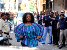 U.S. talk show host Oprah Winfrey poses for the media on a street in Mumbai, India, Tuesday, Jan. 17, 2012. (AP Photo/Rajanish Kakade)