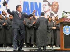 Comedian and Charleston native Stephen Colbert, left, sings to the crowd during the "Rock Me Like a Herman Cain South Cain-olina Primary Rally" at the College of Charleston in Charleston, S.C., on Friday, Jan. 20, 2012. (AP Photo/Bruce Smith).