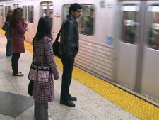 People wait to board a subway train Monday, Jan. 30, 2012.