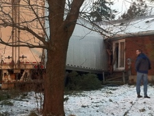 A transport truck crashed into a house east of Arthur on Tuesday, Dec. 13, 2011. The house was knocked off the foundation, and the truck portion of the vehicle ended up in the basement.