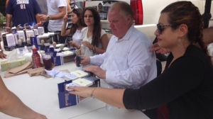 Mayor Rob Ford signs bobbleheads