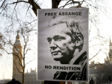 Supporters hold a banner as they await the arrival of Julian Assange WikiLeaks founder at the Supreme Court in London, Wednesday, Feb. 1, 2012. Assange's legal team is making a final effort at Britain's Supreme Court to avoid his extradition to Sweden. Assange is wanted by Swedish authorities over sex crimes allegations stemming from a visit to the country in 2010. He denies any wrongdoing. (AP Photo/Kirsty Wigglesworth)