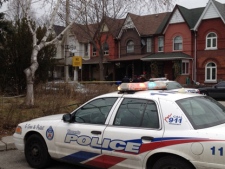Toronto police investigate after a woman's body was found in a laneway behind a Clendenan Avenue address Wednesday, Feb. 1, 2012. (CTV/Jeff Wood)