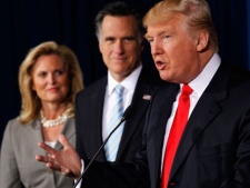 Donald Trump speaks at a news conference in Las Vegas on Thursday, Feb. 2, 2012, to endorse Republican presidential candidate, former Massachusetts Gov. Mitt Romney, center, accompanied by Romney's wife Ann. (AP Photo/Gerald Herbert)