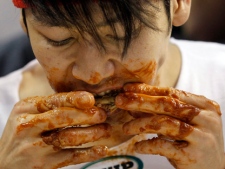 Japanese competitive eater Takeru Kobayashi eats chicken wings during SportsRadio WIP�s Wing Bowl 2012 eating contest Friday, Feb. 3, 2012, in Philadelphia. Kobayashi won by eating 337 wings. The annual event is held the Friday before the Super Bowl. (AP Photo/Alex Brandon)