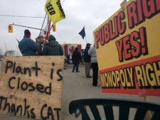 CAW workers picket outside at the Electro-Motive plant in London, Ont., on Friday, feb. 3, 2012. American-based heavy equipment maker Caterpillar Inc. announced Friday it was closing the plant, a month after it locked out about 450 workers. THE CANADIAN PRESS/Mark Spowart