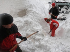 Merim Muslibegovic, left, and his daughters Senka, 15, and Sara, 7, shovel deep snow to clear his car in the Bosnian capital of Sarajevo on Saturday, Feb. 4, 2012. (AP Photo/Amel Emric)
