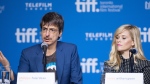 Actor Reese Witherspoon listens as director Philippe Falardeau speaks during a press conference for "The Good Lie" at the 2014 Toronto International Film Festival in Toronto on Monday, Sept. 8, 2014. THE CANADIAN PRESS/Hannah Yoon