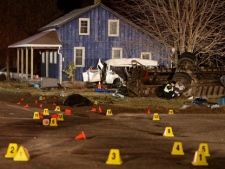 Ontario Provincial Police and emergency crews investigate a fatal crash in Hampstead, Ont., on Monday, Feb. 6, 2012. Police say 11 people died in the crash. (THE CANADIAN PRESS/Dave Chidley)
