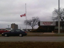 A flag flies at half-mast outside Speedy Transport in Brampton on Tuesday, Feb. 7, 2012, a day after an employee was one of 11 people killed in a crash in Hampstead, Ont. (CTV/Austin/Delaney)