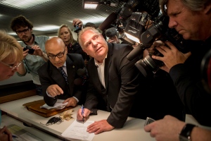 Doug Ford tries to avoid the glare of a television camera as he submits his papers in Toronto on Friday, September12, 2014 to enter the mayoral race after the withdrawal of Rob Ford. THE CANADIAN PRESS/Chris Young