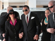 Muhammad Ali, center, and his wife, Lonnie, left, arrive for the funeral for legendary boxing trainer Angelo Dundee, at the Countryside Christian Center in Clearwater, Fla., Friday, Feb. 10, 2012. (AP Photo/Jeff Julien)