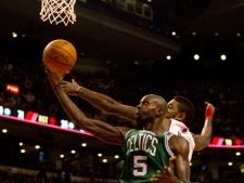 Boston Celtics' Kevin Garnett battles for control of the ball with Toronto Raptors' Amir Johnson during second half NBA play in Toronto on Friday, Feb. 10, 2012. (THE CANADIAN PRESS/Pawel Dwulit)