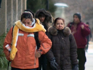 People bundle up as they walk along a Toronto street in this file photo.