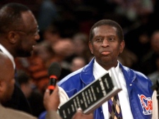 Earl Lloyd, right, is honored with a plaque from Bob Lanier, special assistant to the commissioner of the NBA, on the 50th anniversary of Lloyd's becoming the first black player in the NBA during a ceremony before a game between the New York Knicks and the Philadelphia 76ers at Madison Square Garden in New York, Tuesday, Oct. 31, 2000. (AP Photo/Jeff Zelevansky)