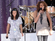 Singer Whitney Houston, right, sings with her daughter Bobbi Kristina Brown during a performance for 'Good Morning America' in Central Park on Tuesday, Sept. 1, 2009 in New York. (AP Photo/Evan Agostini) 