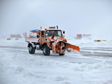 A snow plough clears the tarmac at Slatina airport, Kosovo, Thursday, Feb. 2, 2012. Exceptionally cold weather and snowstorms have affected parts of central and eastern Europe, as dozens of flights were canceled Thursday by inclement weather. (AP Photo/Visar Kryeziu)