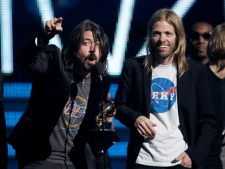 Dave Grohl, left, and his Foo Fighters bandmates accept the award for best rock performance for "Walk" during the 54th annual Grammy Awards on Sunday, Feb. 12, 2012, in Los Angeles. (AP Photo/Matt Sayles)